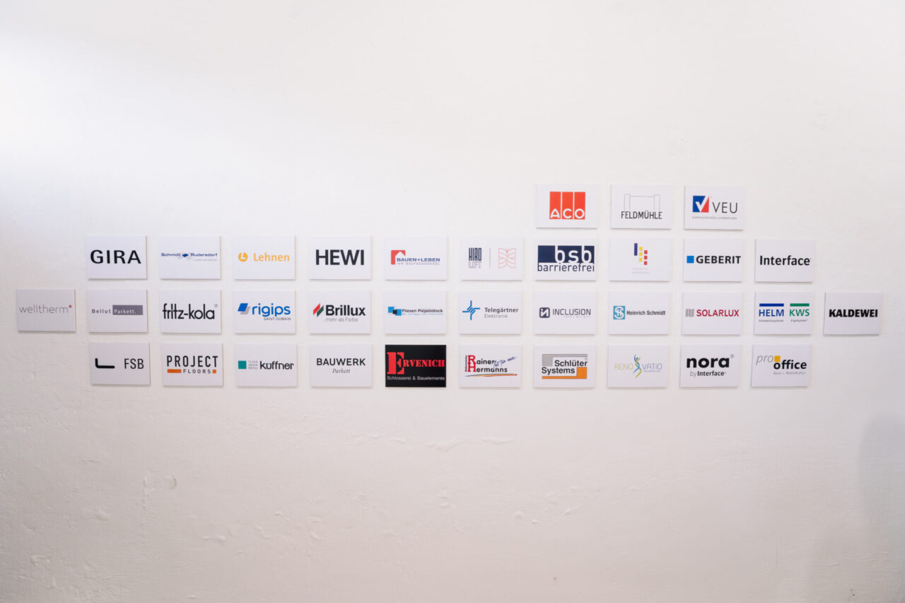 Weiße Wand mit Schildern von Kooperationspartnern